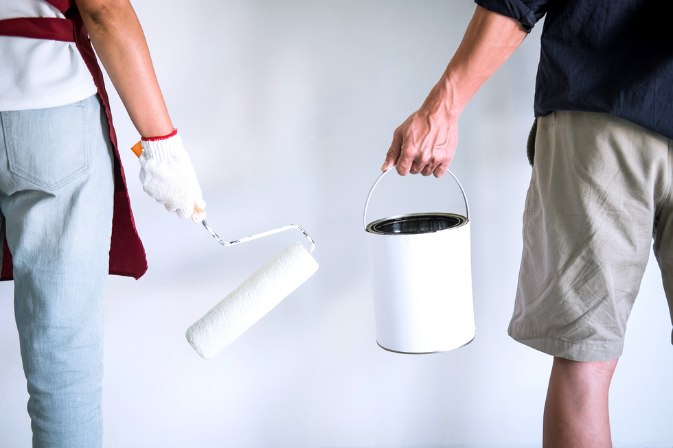 Two People Ready to Paint the Wall With Paint Roller
